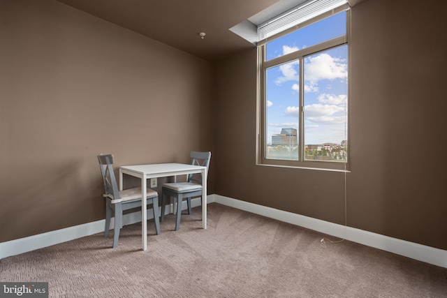 dining space with light colored carpet