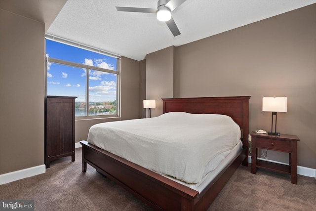 bedroom featuring dark carpet and ceiling fan