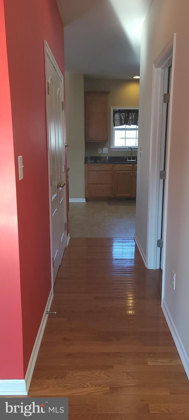 hallway with dark hardwood / wood-style flooring