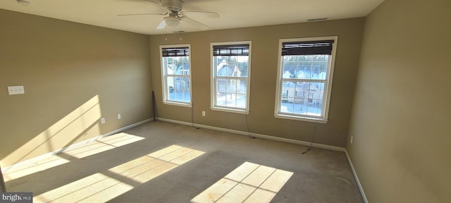 carpeted empty room featuring ceiling fan