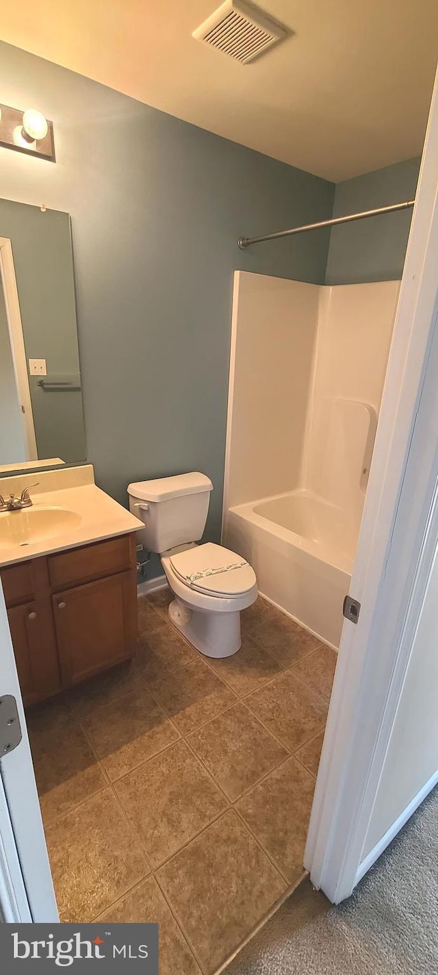 full bathroom with washtub / shower combination, vanity, toilet, and tile patterned flooring