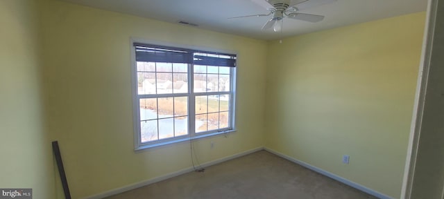 carpeted spare room with ceiling fan