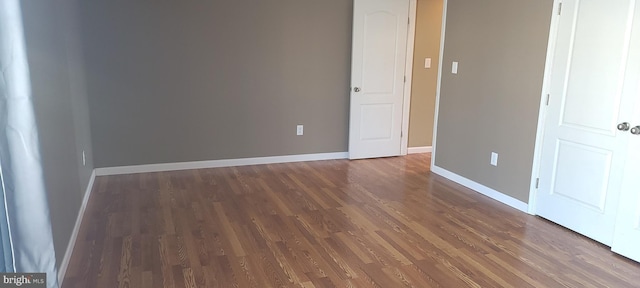 empty room with dark hardwood / wood-style floors