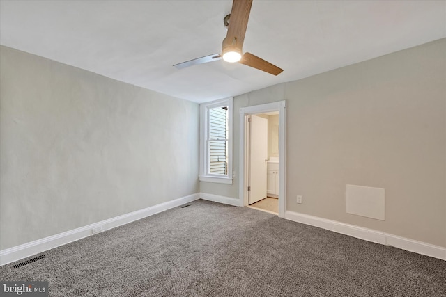 unfurnished bedroom with ensuite bath, ceiling fan, and carpet flooring