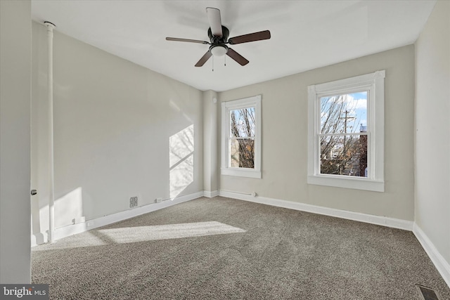 carpeted empty room featuring ceiling fan