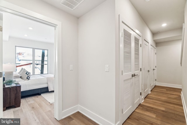 hall with light hardwood / wood-style flooring