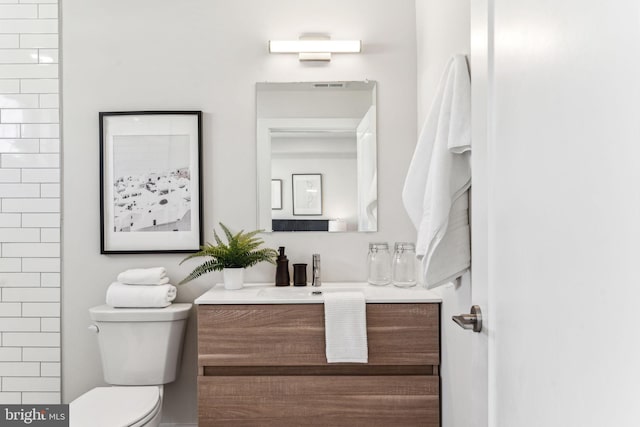 bathroom featuring vanity and toilet