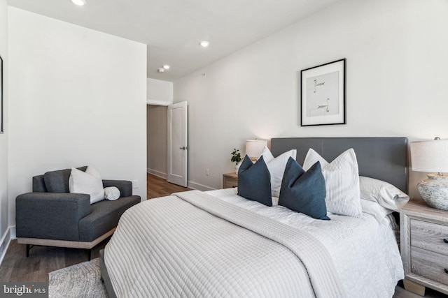 bedroom with dark hardwood / wood-style flooring