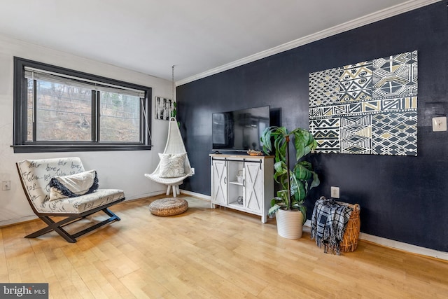 sitting room featuring hardwood / wood-style floors and crown molding