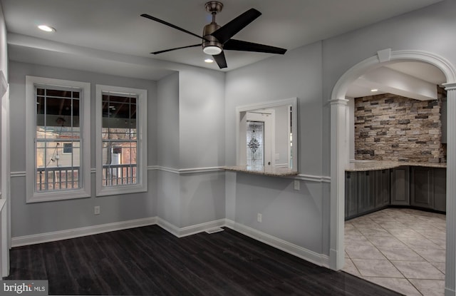 spare room with hardwood / wood-style floors and ceiling fan