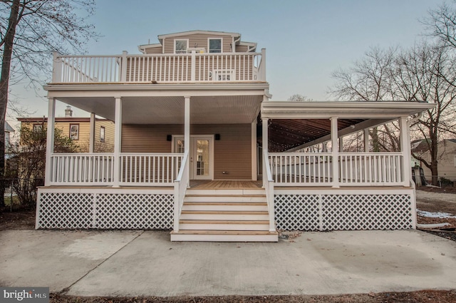 view of front of property with a porch and a balcony