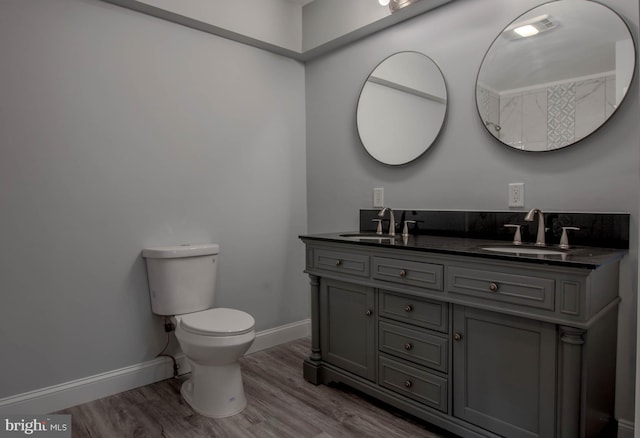 bathroom with vanity, toilet, and hardwood / wood-style floors