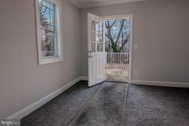 doorway with ornamental molding and dark carpet