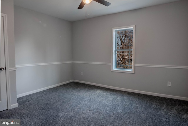 carpeted spare room featuring ceiling fan