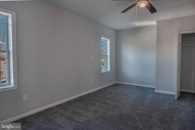 unfurnished bedroom with dark carpet