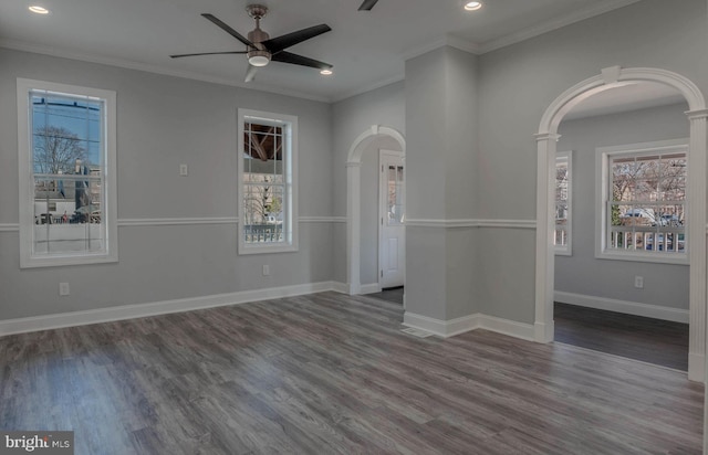 unfurnished room with crown molding, dark wood-type flooring, and ceiling fan