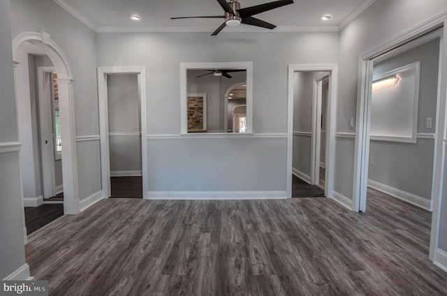 unfurnished bedroom featuring dark wood-type flooring, ornamental molding, and ceiling fan