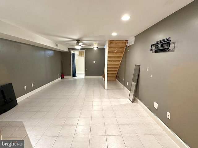 tiled spare room featuring ceiling fan