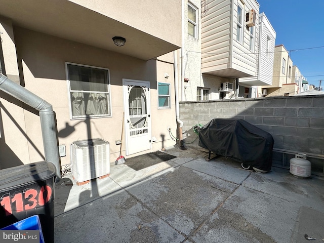 view of patio featuring a grill and central air condition unit