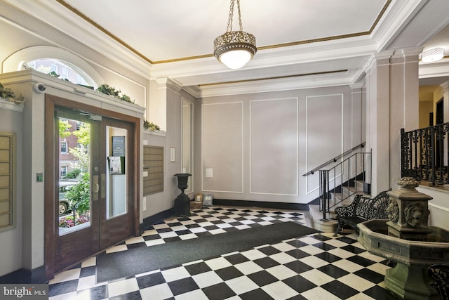 foyer entrance with crown molding and decorative columns