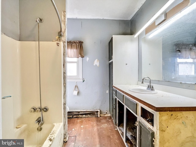 full bath featuring shower / bathtub combination, wood finished floors, and vanity