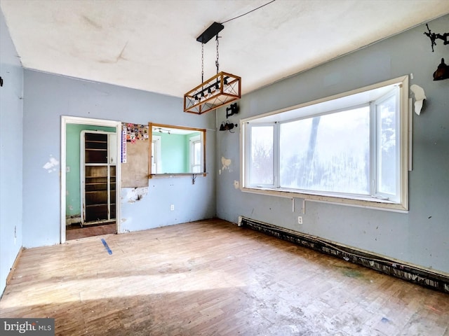 unfurnished dining area featuring wood finished floors