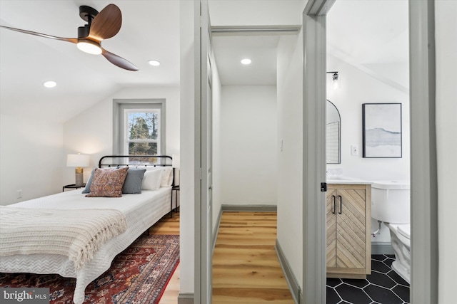 bedroom with lofted ceiling, hardwood / wood-style floors, and ceiling fan