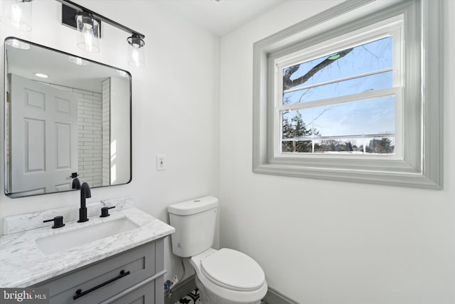 bathroom featuring vanity and toilet