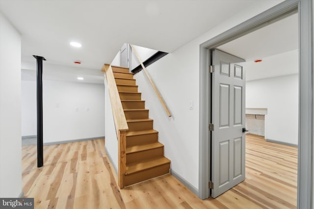 stairs with hardwood / wood-style floors