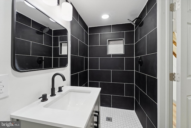 bathroom with vanity and tiled shower