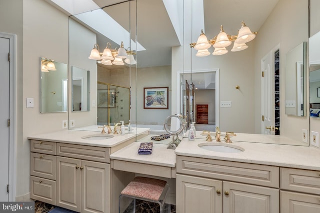 bathroom featuring vanity, an enclosed shower, and a chandelier