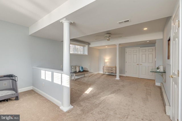 interior space featuring light colored carpet and ceiling fan