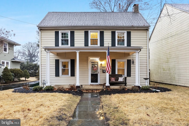 view of front facade with covered porch and a front yard