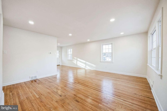 unfurnished room with light hardwood / wood-style floors and a wealth of natural light