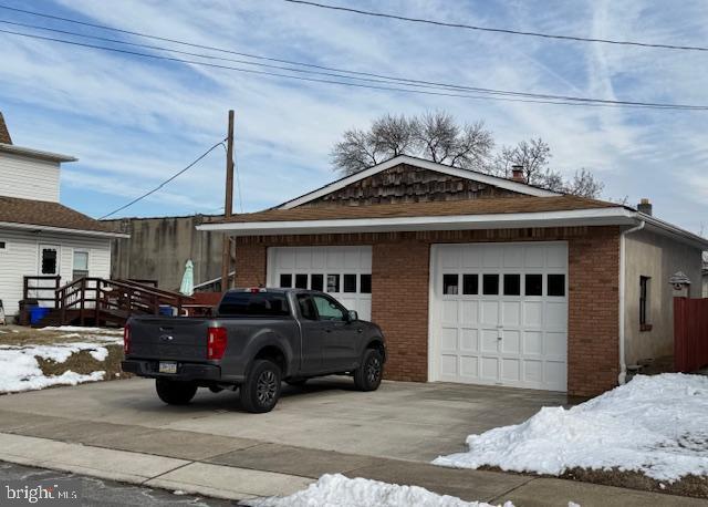 exterior space featuring a garage and an outdoor structure