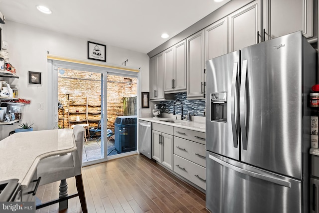 kitchen featuring dark hardwood / wood-style flooring, sink, gray cabinets, and appliances with stainless steel finishes