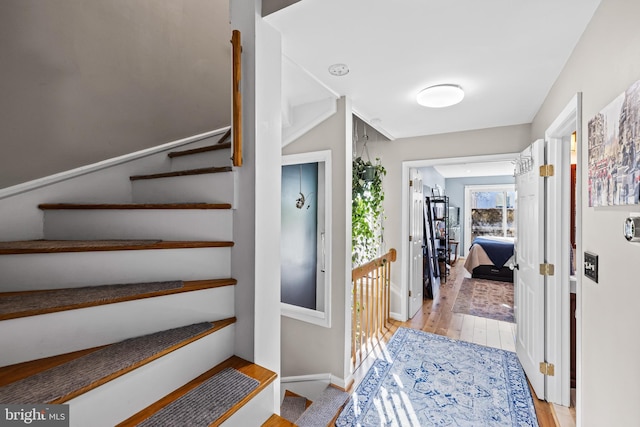 stairs with hardwood / wood-style floors