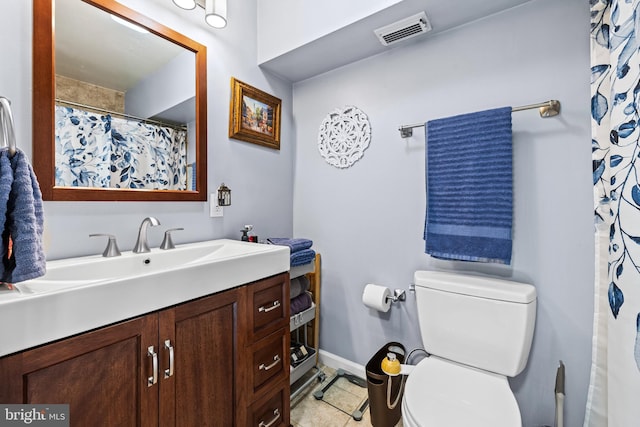 bathroom with vanity, tile patterned floors, and toilet