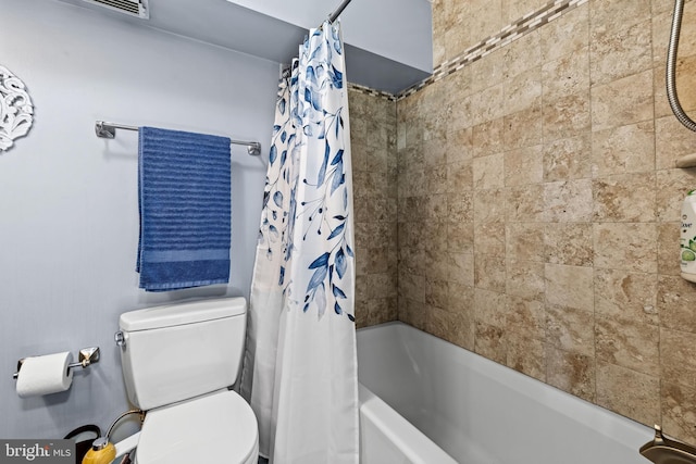 bathroom with shower / tub combo with curtain and toilet