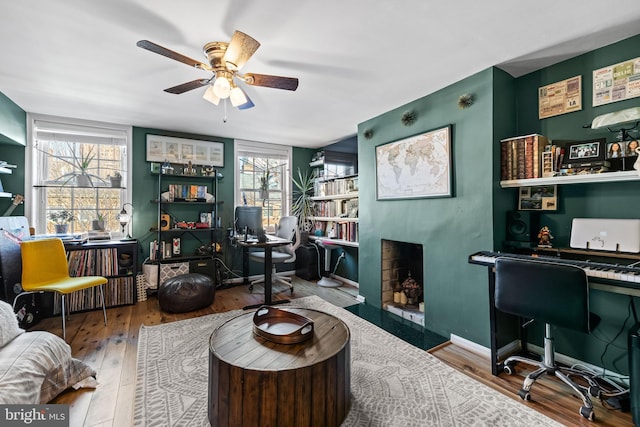 interior space with hardwood / wood-style flooring, ceiling fan, and plenty of natural light