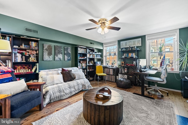 living room with ceiling fan and wood-type flooring