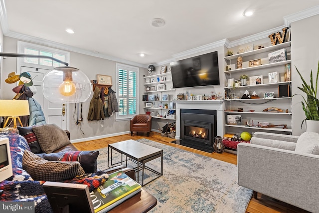 living room with ornamental molding and hardwood / wood-style floors