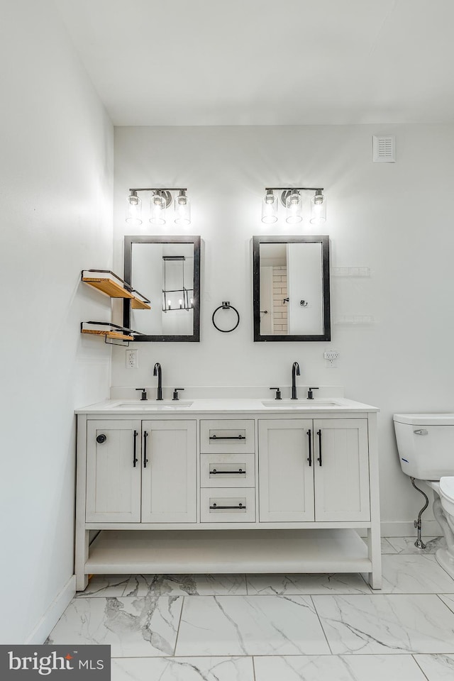 bathroom featuring vanity and toilet