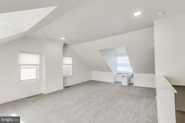 bonus room featuring light colored carpet and lofted ceiling