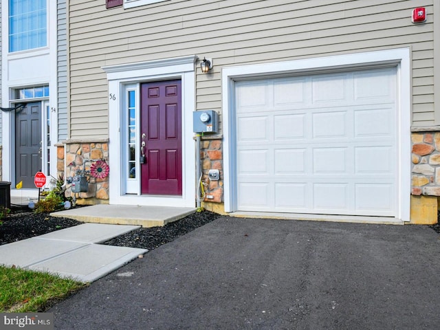 doorway to property with a garage