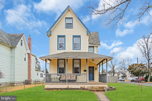 view of front of house with covered porch and a front lawn