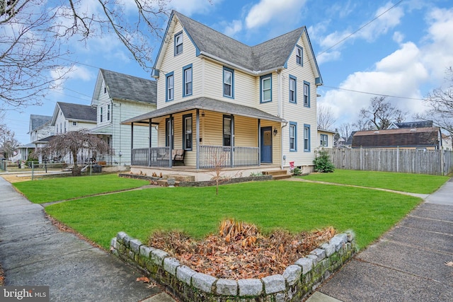 view of front of home with a front yard and covered porch