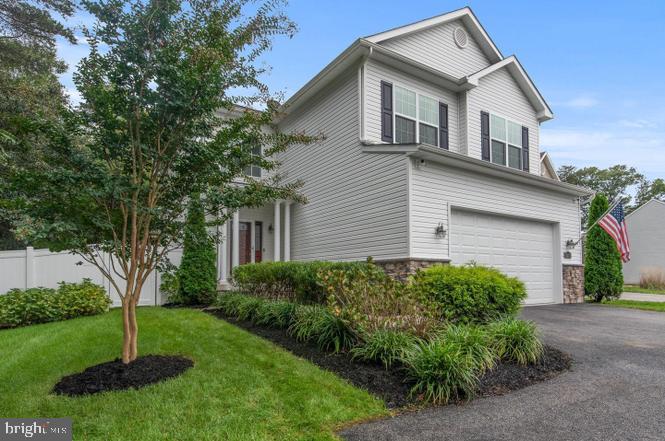 view of front of property with a garage and a front yard