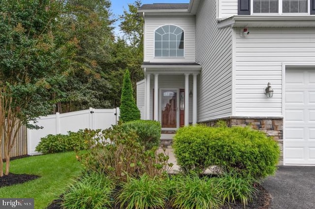 view of exterior entry with a garage