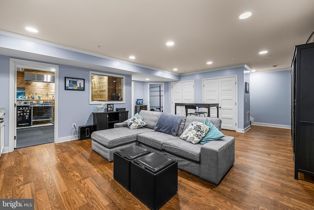 living room featuring crown molding and dark hardwood / wood-style flooring